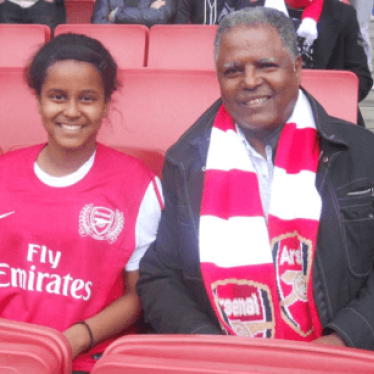 Mr Tsege and his daughter Helawit, watch Arsenal play in 2013.