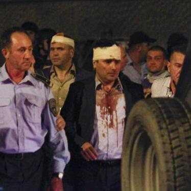 Macedonian police escort injured members of the parliament including Social Democratic leader Zoran Zaev.