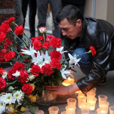 A man leaves flowers during a memorial service for victims of a blast in St.Petersburg metro, outside Sennaya Ploshchad metro station in St. Petersburg, Russia. 
