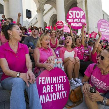 Activists chant as they rally in support of Planned Parenthood on "National Pink Out Day" on the steps of City Hall in Los Angeles, California on September 29, 2015.