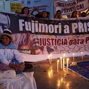Relatives of victims of the guerrilla conflict in the 1980s and 1990s protest outside a court before a hearing on former Peruvian President Alberto Fujimori's pending trials, Lima, Peru, January 25, 2018. The banner reads: "Fujimori to prison, justice for