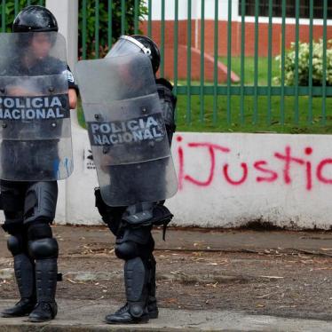 Riot police officers stand in front of a graffiti that reads "Justice" during a protest against Nicaragua's President Daniel Ortega's government in Managua, Nicaragua May 28, 2018. 