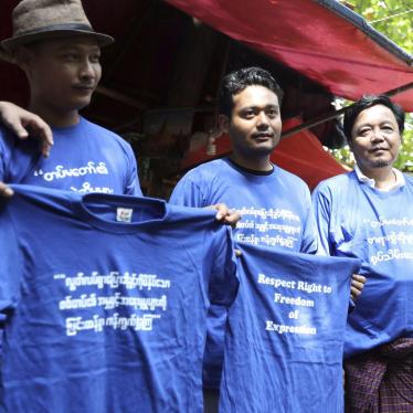 Activists hold blue shirts that read; "Condemning on charge by military oppressing freedom of expression," during the trial of members of the Student Union and leaders of Peacock Generation "Thangyat" Performance Group, Wednesday, Oct. 30, 2019, in Yangon