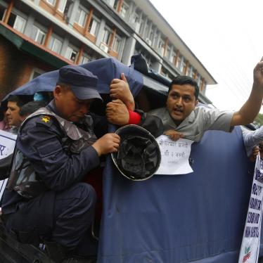 Nepalese activists shout slogans after being detained by police during a protest against the government, in front of the prime minister's office in Kathmandu, Nepal, Tuesday, July 10, 2018. 