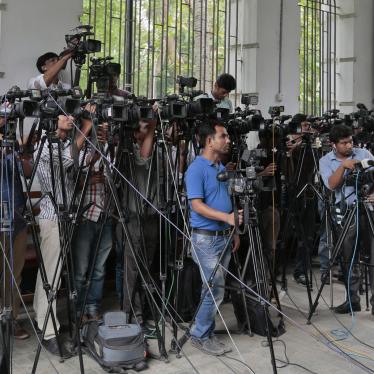 In this May 3, 2016 file photo, Bangladeshi journalists cover proceedings outside a court in Dhaka, Bangladesh. 